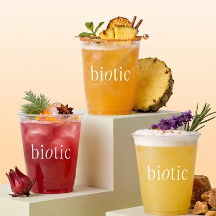 Three biotic cups with fruit and flowers on white blocks