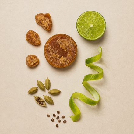 Tamarind, cardamom and a curl of lime peel on cream paper