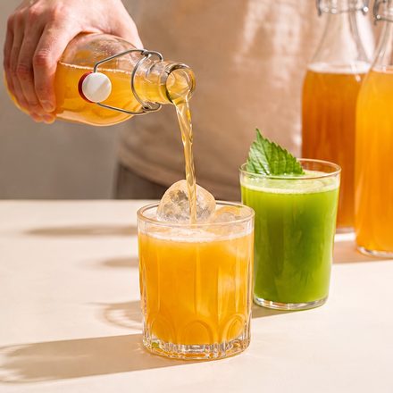 Golden ferment poured into glasses on a pale table