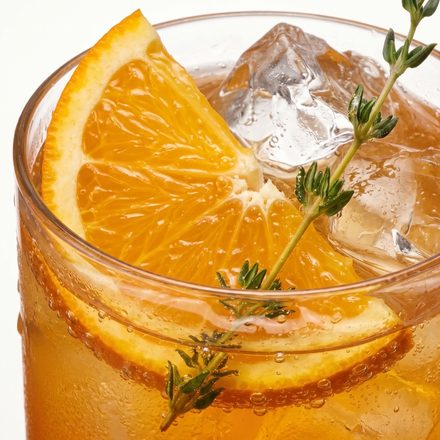 Orange slices and ice filling a tall glass