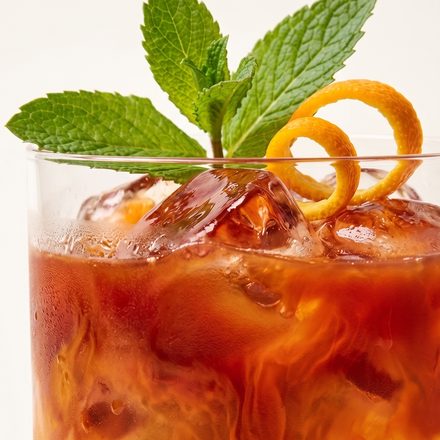 Iced tea with mint and a curl of orange peel