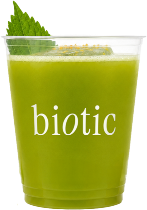 Bright green apple and shiso drink over ice in a tumbler