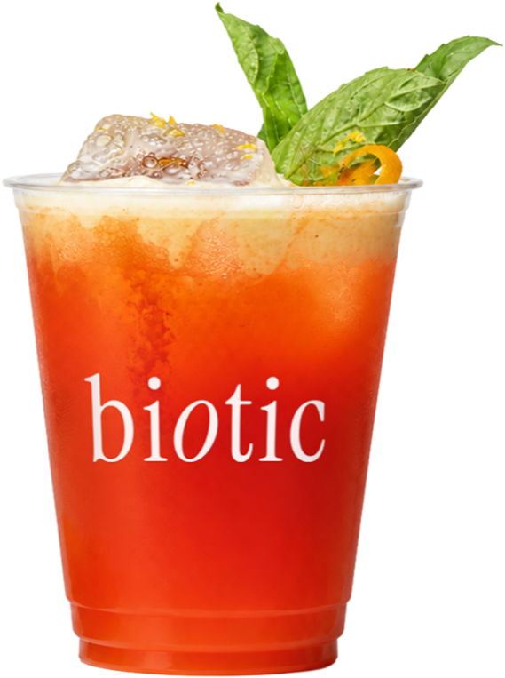 Raspberry and mango drink in a plastic takeaway cup with herbs and an orange twist